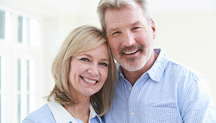 Older couple with healthy flawless smiles