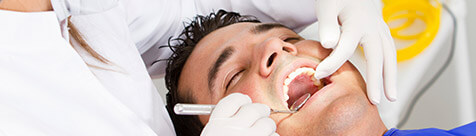 Male patient being treated in dental chair