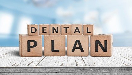 Wooden blocks spelling “dental plan”