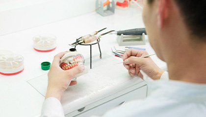 Laboratory technician building dentures