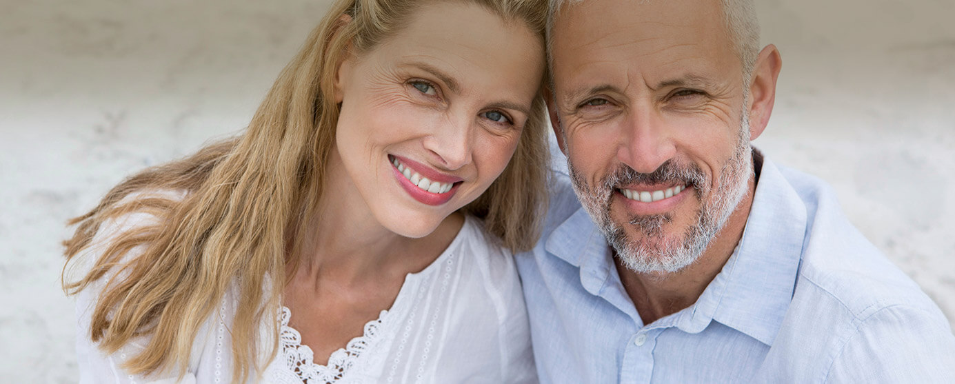 Close up of smiling older couple on the beach