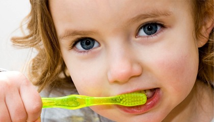 young girl brushing her teeth