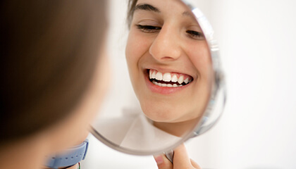Patient looking at smile in mirror