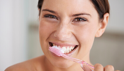 Female patient brushing teeth