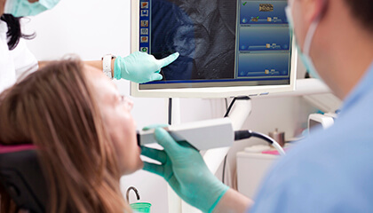 Patient and dentist examine intraoral photo