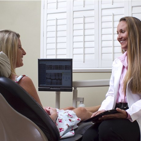 Dentist talking with patient