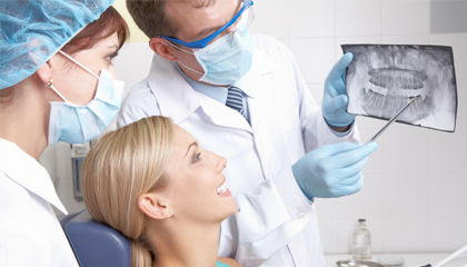 Woman and dentist looking at dental x-rays