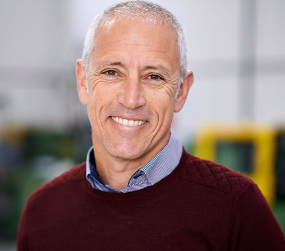 Smiling older man wearing red sweater