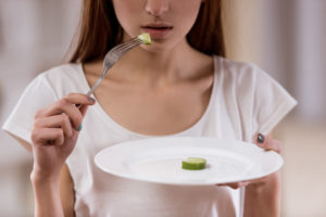 anorexic woman eating tiny portion