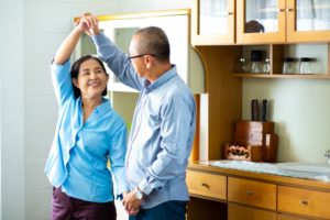 worry-free couple dancing in their kitchen