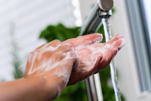 Your Melbourne dentist washing their hands thoroughly 