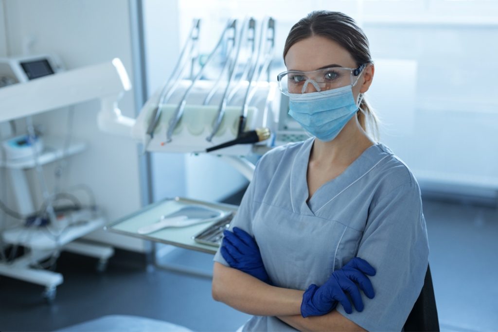 Dentist wearing protective equipment