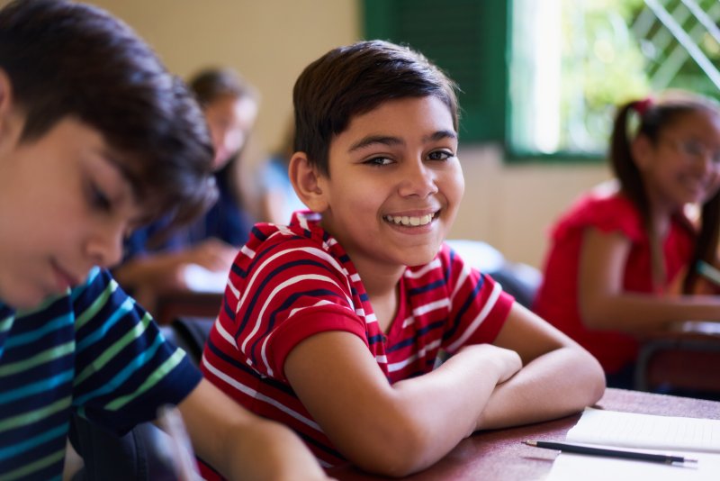 young child smiling in school