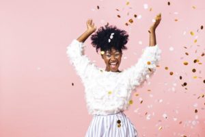 Woman throwing confetti to celebrate her healthier smile in Melbourne