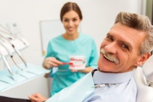 Smiling older man at dentist for seniors