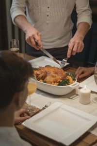 Man cutting turkey for Thanksgiving