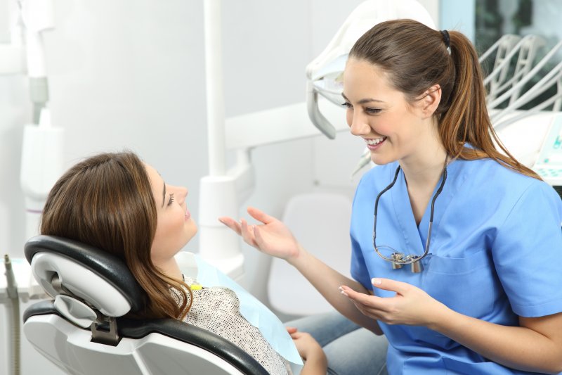 dental assistant smiling while talking to patient