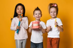 children smiling and celebrating Children's Dental Health Month