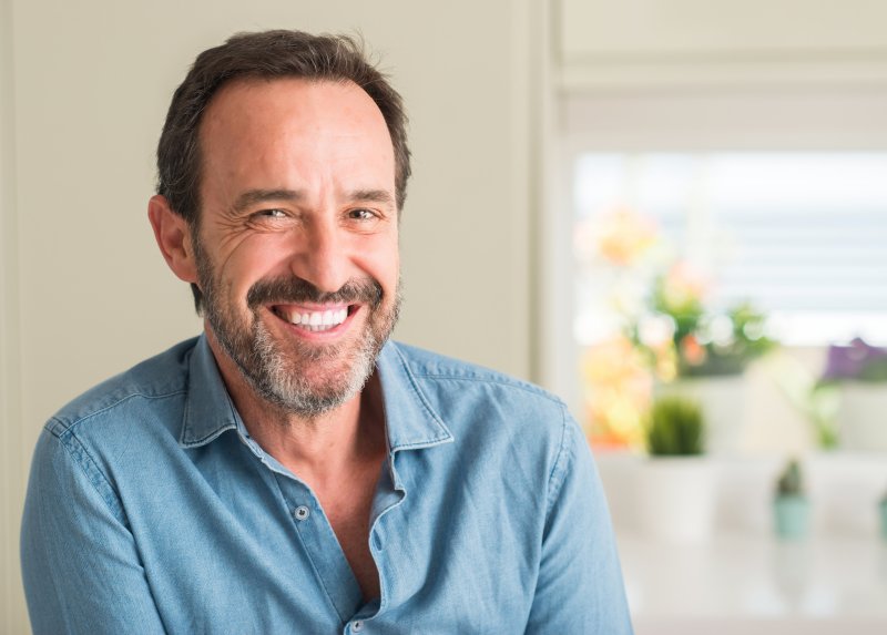 A man smiling after his cosmetic dentistry treatments