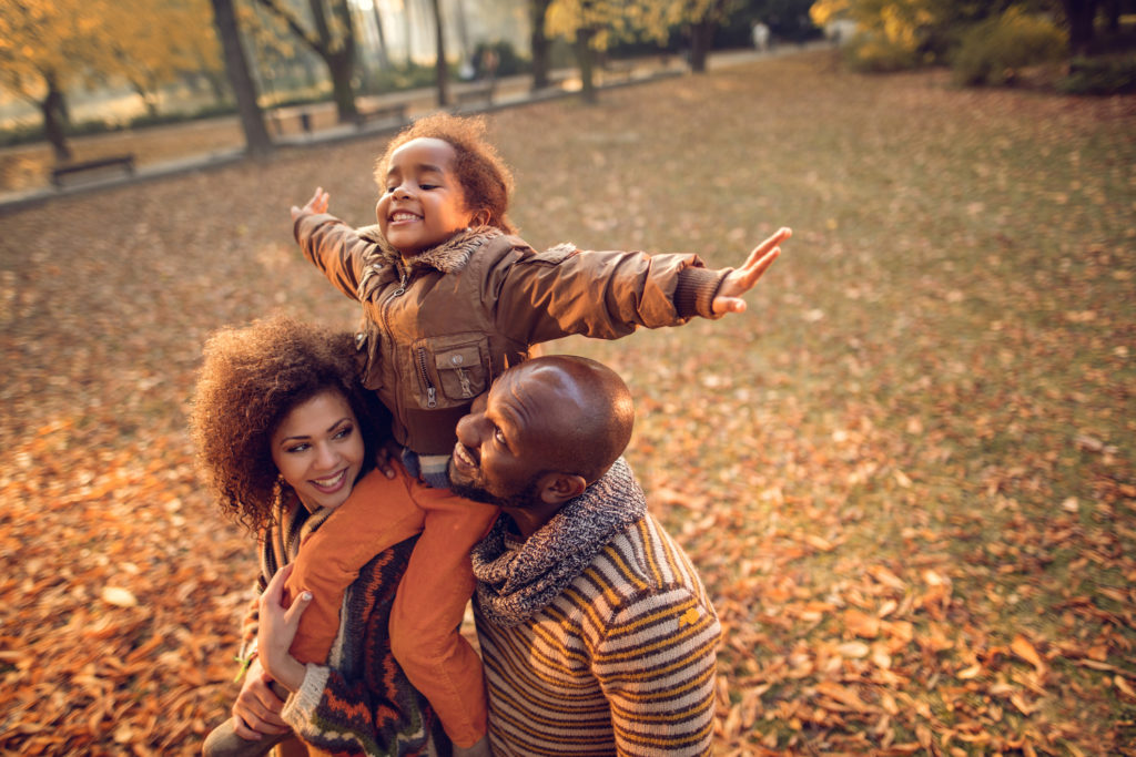 Family playing in the leaves