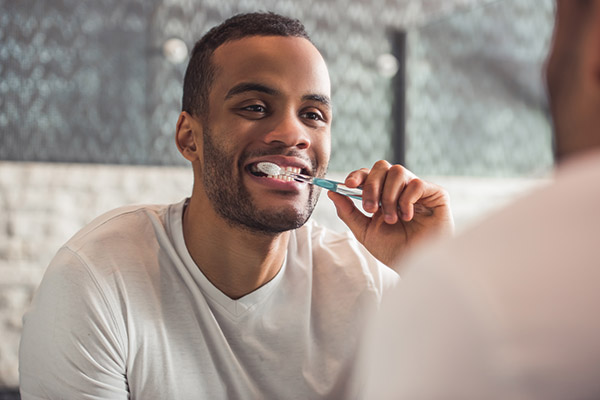 dental tool removing plaque from a smile