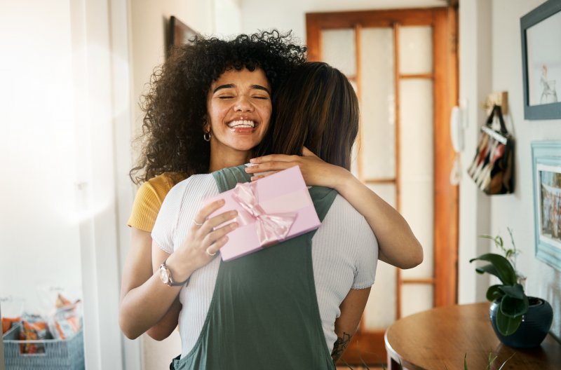 A family smiling as they exchange dentist-approved stocking stuffers