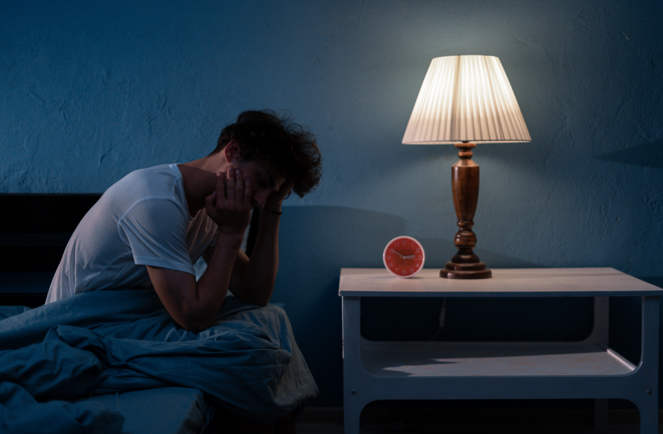 Man in bed holding jaw