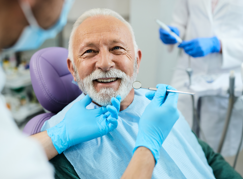 Older man with dentures at dental exam